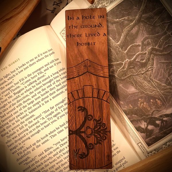 Walnut bookmark engraved with 'In a hole in the ground there lived a hobbit' above a round hobbit door