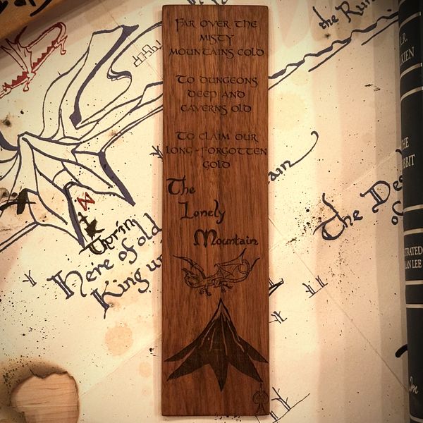 Walnut bookmark engraved with 'Far over the misty mountains cold', The Lonely Mountain, a dragon and a mountain peak